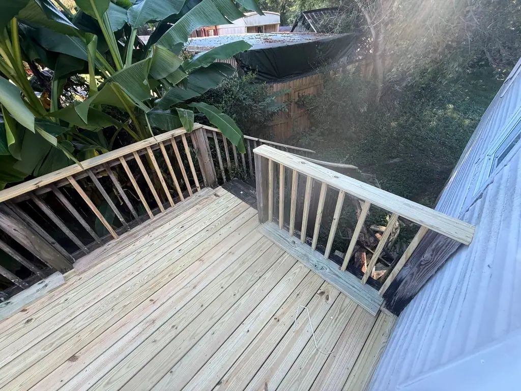 New deck boards and railing built off the back of a house