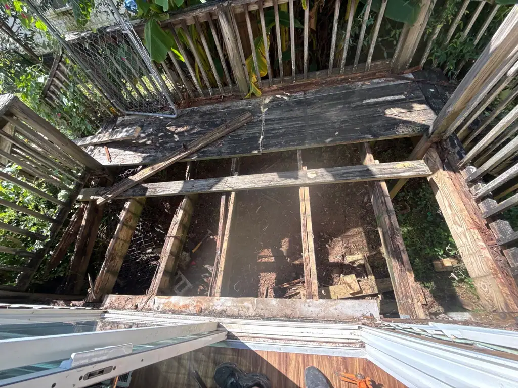 Rotted deck boards and joists before the rebuild