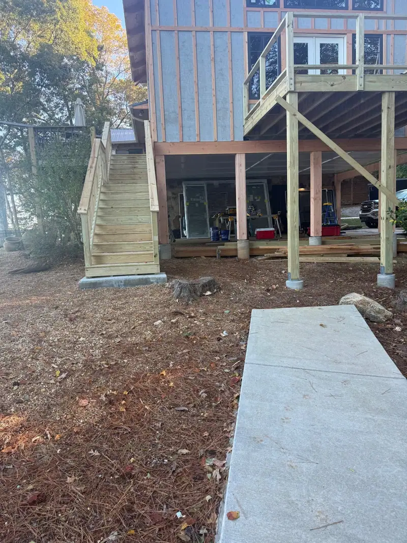 New deck stairs and posts on the back of a raised house