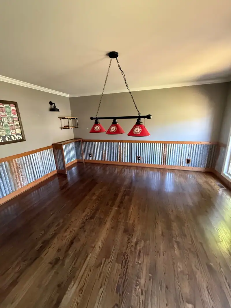 Finished game room with hardwood floors and corrugated wainscot