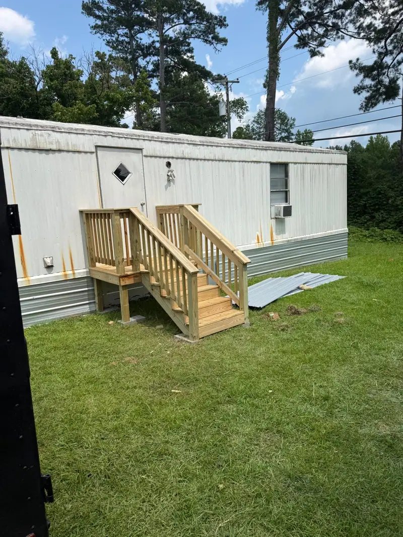 New wooden steps and railing built at a mobile home door