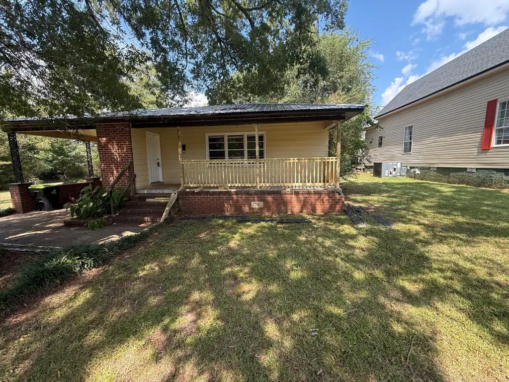 Front porch with new railings on a brick foundation