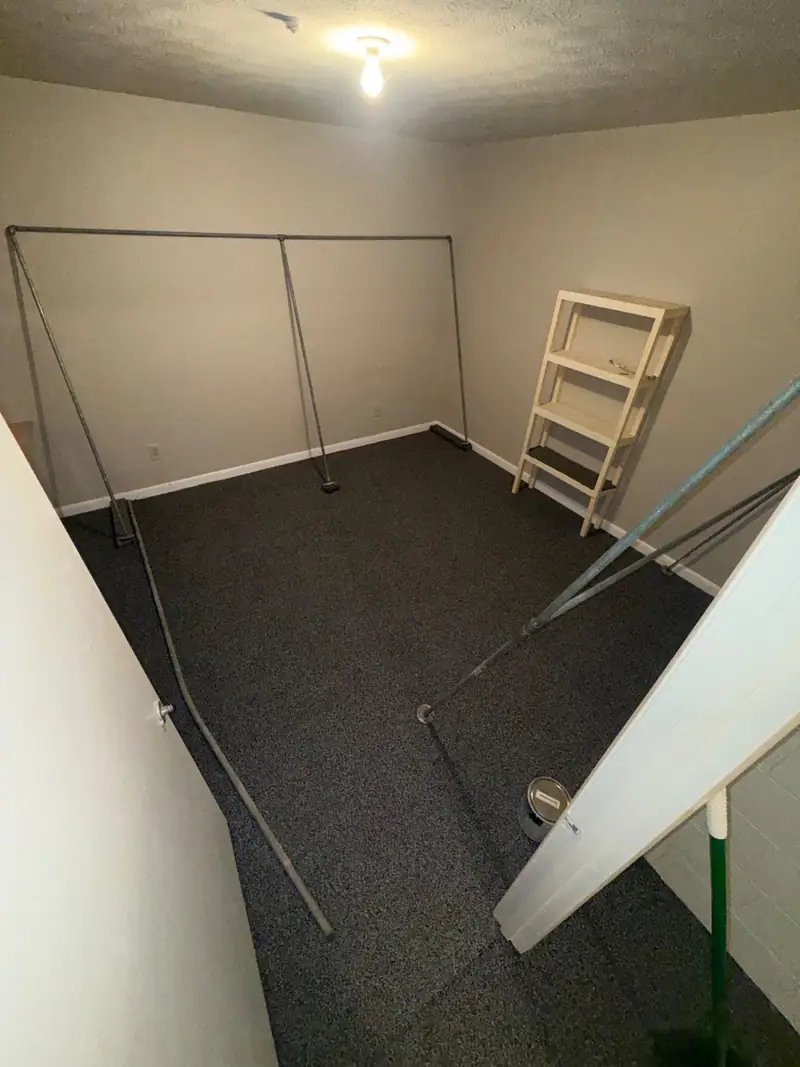 The same room rebuilt with new carpet and clean walls
