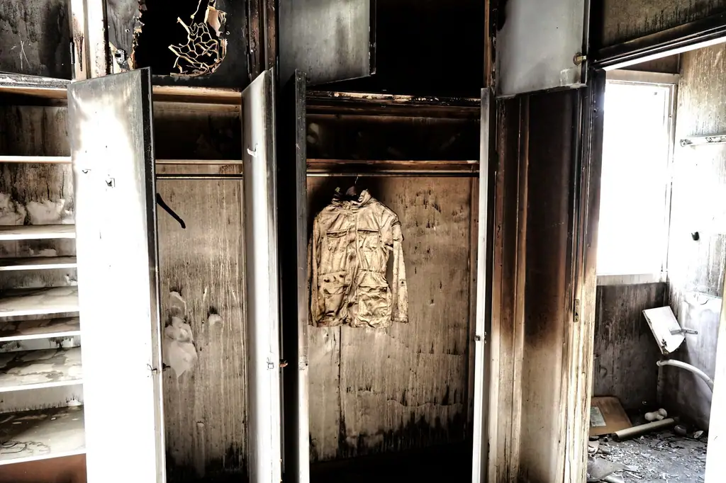 Closet scorched by fire with smoke stains up the walls