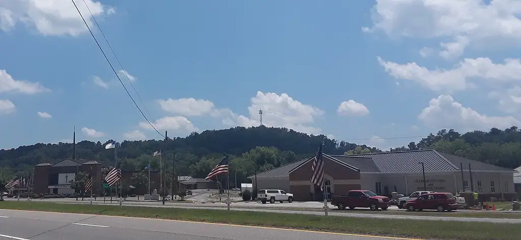 City Hall of Glencoe, Alabama (right), First Baptist Church of Glencoe (left), with Memorial Day flags in the foreground. Picture taken from across US Highway 431 on May 28th 2019